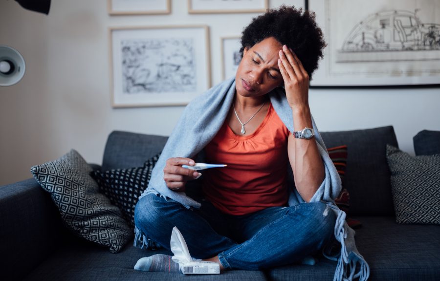 Young woman feeling symptoms of an illness